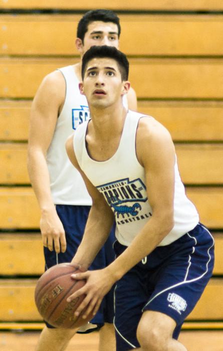During practice, Diego Gonzalez, senior, spies the hoop as he prepares to take a shot.