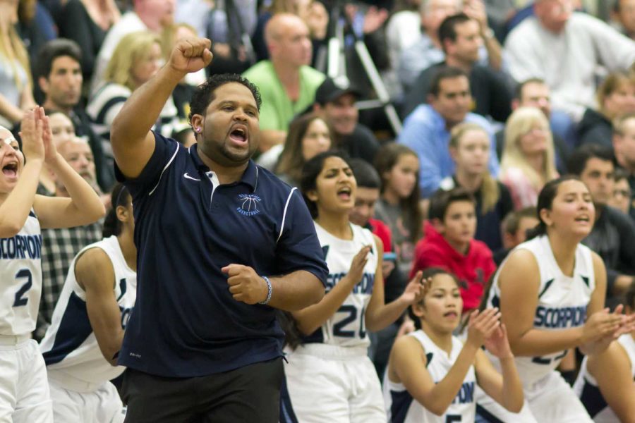 Coach Michaeltore Smith and the Girls' Varsity Basketball team cheer after Dynn Leaupepe scored Camarillo's 54th point. Smith will head the boys' basketball team in the fall.