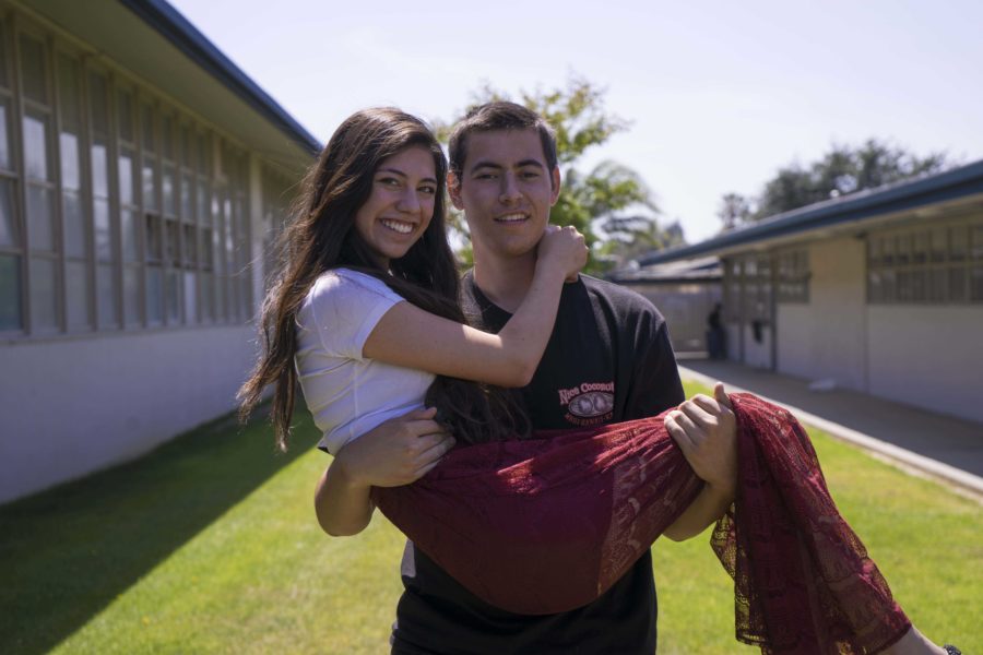 Michael Griffin and Danika Elvine, seniors, prep for the prom. Griffin worked to earn the money for the two tickets.