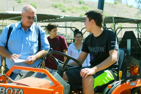 Mr. Swanson working with Mason Ecsedy, freshman, as part of the Agricultural Academy