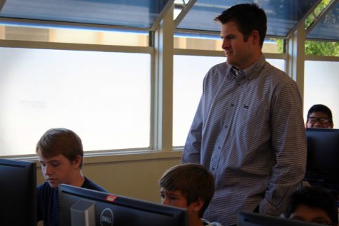 Mr. Foster, working with his students in his Business and Technology class