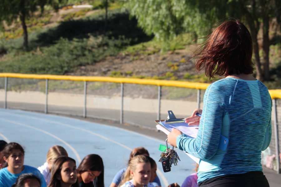Mrs. Mary Perez gives a motivational speech to the girls cross country team, who will hold a fundraiser on November 15.