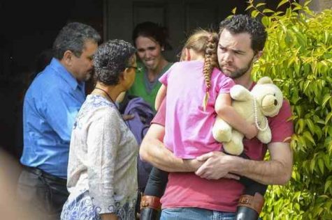 Lexi's foster father Rusty Page (carrying her) and foster mother Summer Page, cry as social workers take Lexi from her home.