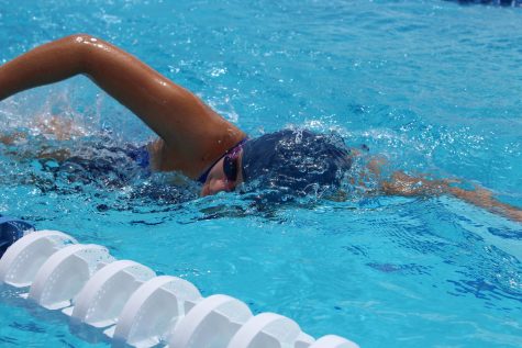 A male Cam High athlete competing against royal in a time trial race