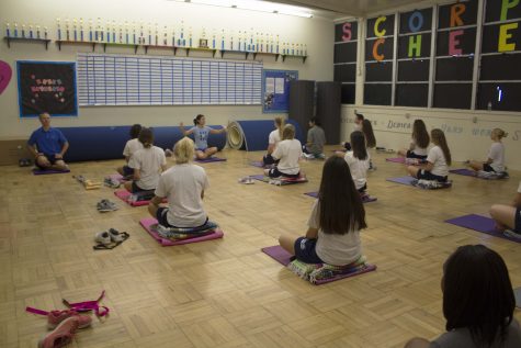 Ms. Claudia Grafenstein teaching yoga to her second period class.