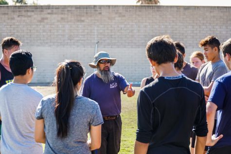 Coach Frances Lepepe gives the team feedback on their scrimmage.