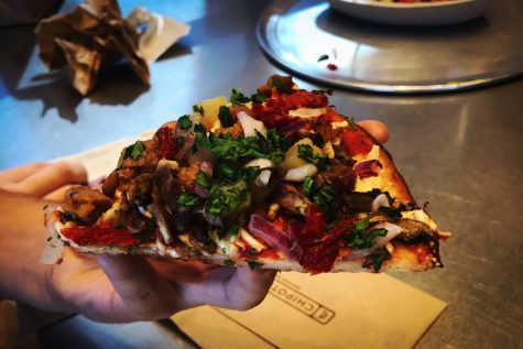 Vegan pizza from PizzaRev made with a gluten free crust, vegan cheese and a variety of fruits and vegetables.