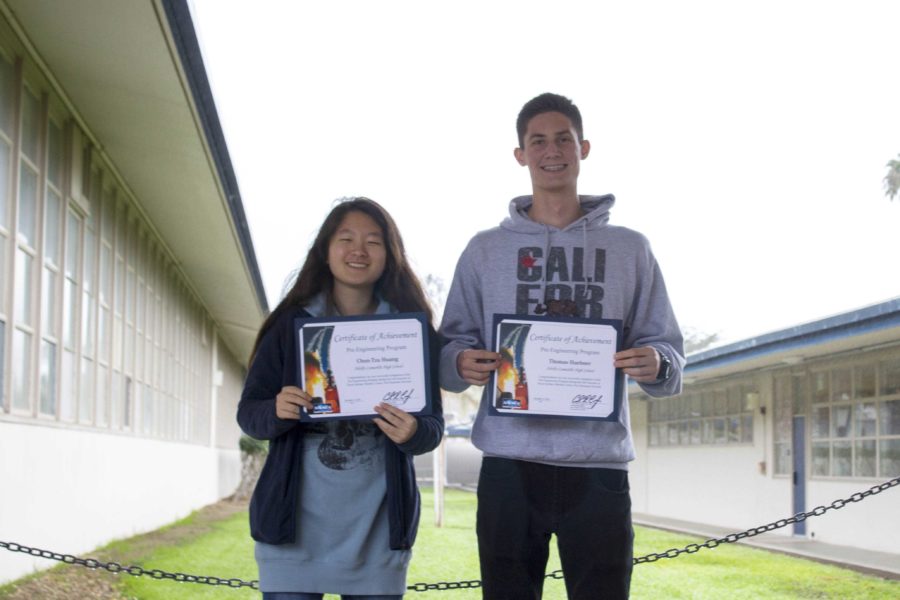 Chun-Tzu Huang and Thomas Huebner (seniors) holding their Pre-Engineering Program certificates of achievement.