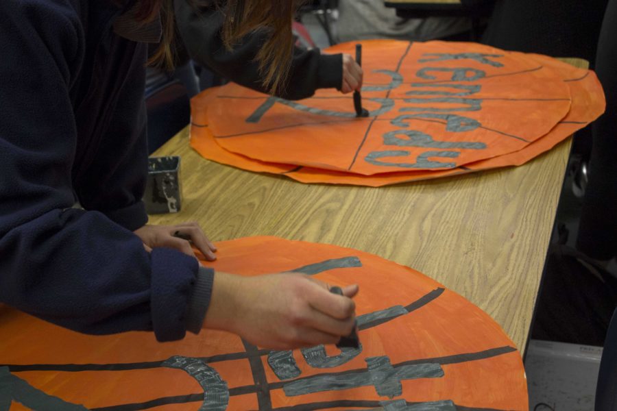 ASB students creating basketball posters for the Cam High varsity basketball players.