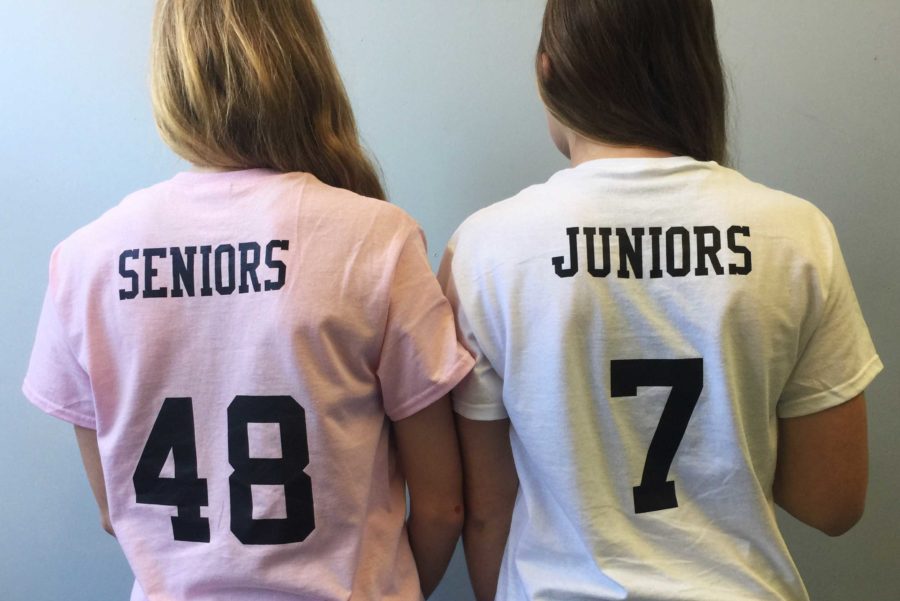 Juniors+and+seniors+stand+together+as+they+prepare+for+the+powderpuff+game.
