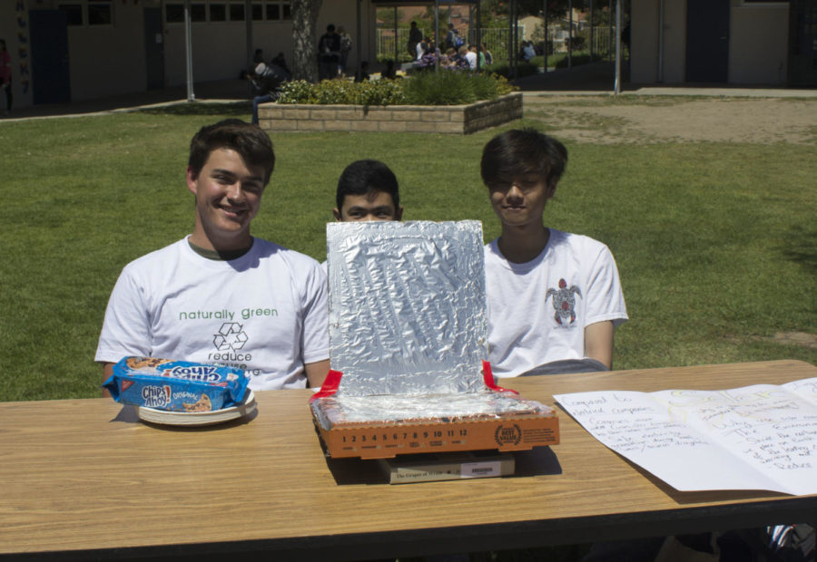 Photo By : Catherine Wolfe (from left to right) Kellen Barsley Junior, Jonathan Lao Junior , and Jon Puno Junior presenting a pizza box microwave at naturally green celebration. 