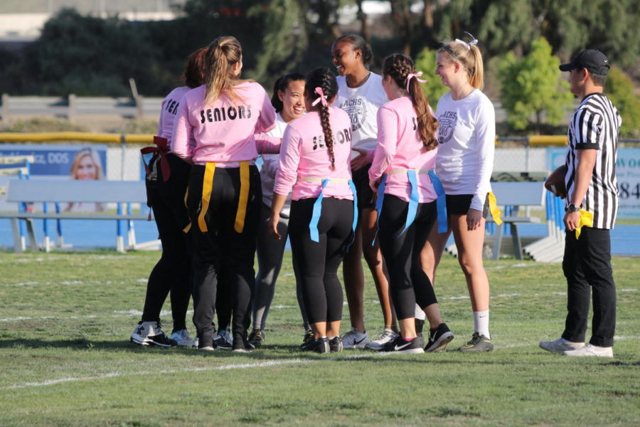 The senior Powder Puff flag football team comes out of a huddle taking on their junior counterparts last month.
