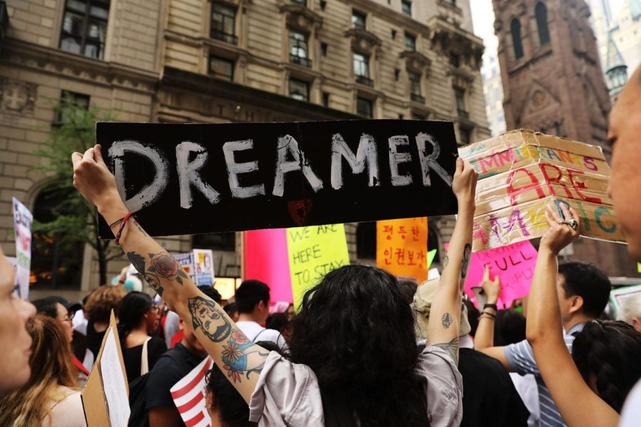 provided by: https://www.popsugar.com

 A protester holding up sign that says DREAMER.
