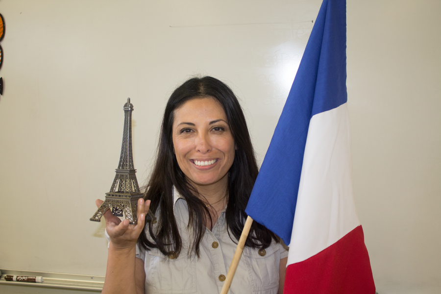 Madame Castro stands with the French flag and the Eiffel Tower. 

Photo by: Ian Lattimer