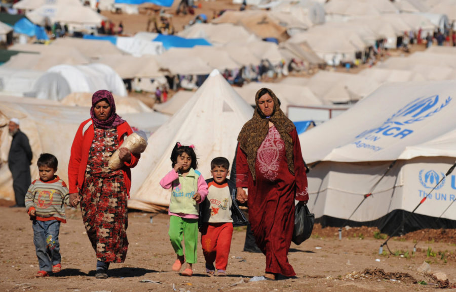 Syrian internally displaced people walk in the Atme camp, along the Turkish border in the northwestern Syrian province of Idlib, on March 19, 2013. 

Photo provided by: Bulent Kilic/Getty Images