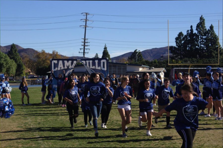 Special Ed and Regular Ed students kick off the Special Olympics soccer game by running through a Cam High banner on Dec. 4, 2018.