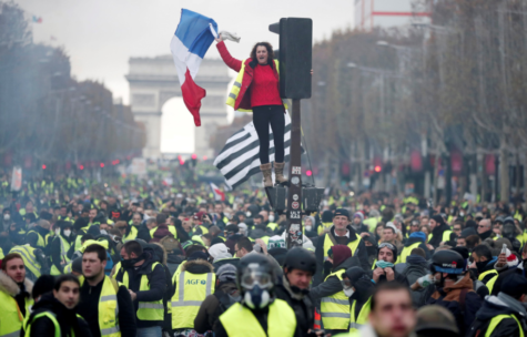 A woman waves a French flag in Paris during the protest of the French government's new fuel tax.