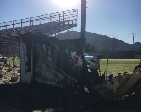The burnt shed is located by the visitor's bleachers in Cam High's stadium.