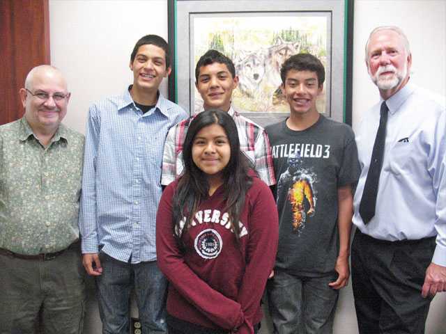 From left to right, Geoffrey Aronsky, students Alejandro Hernandez and Christian Rodriguez, Principal Pete Fries, and student Marisela Sanchez. 